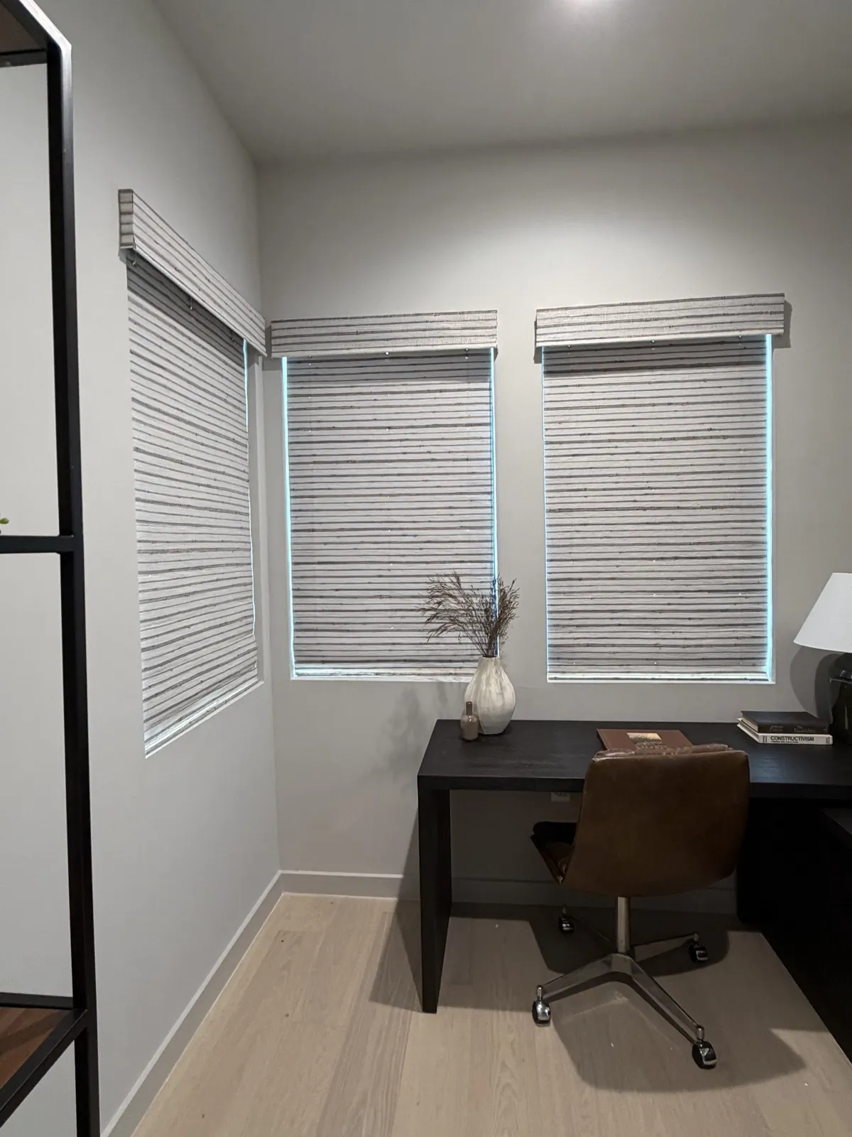 Interior shutters and shades in a bright home office