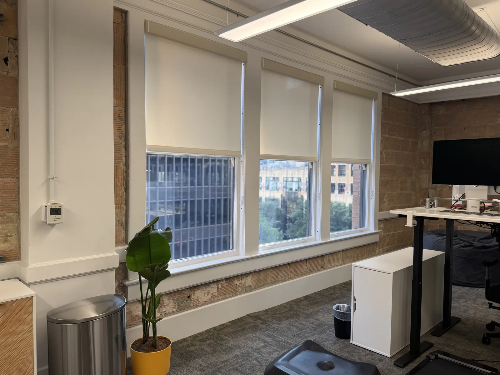 Commercial office with roller shades along a full window wall